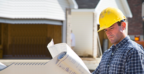 Construction worker reading plans